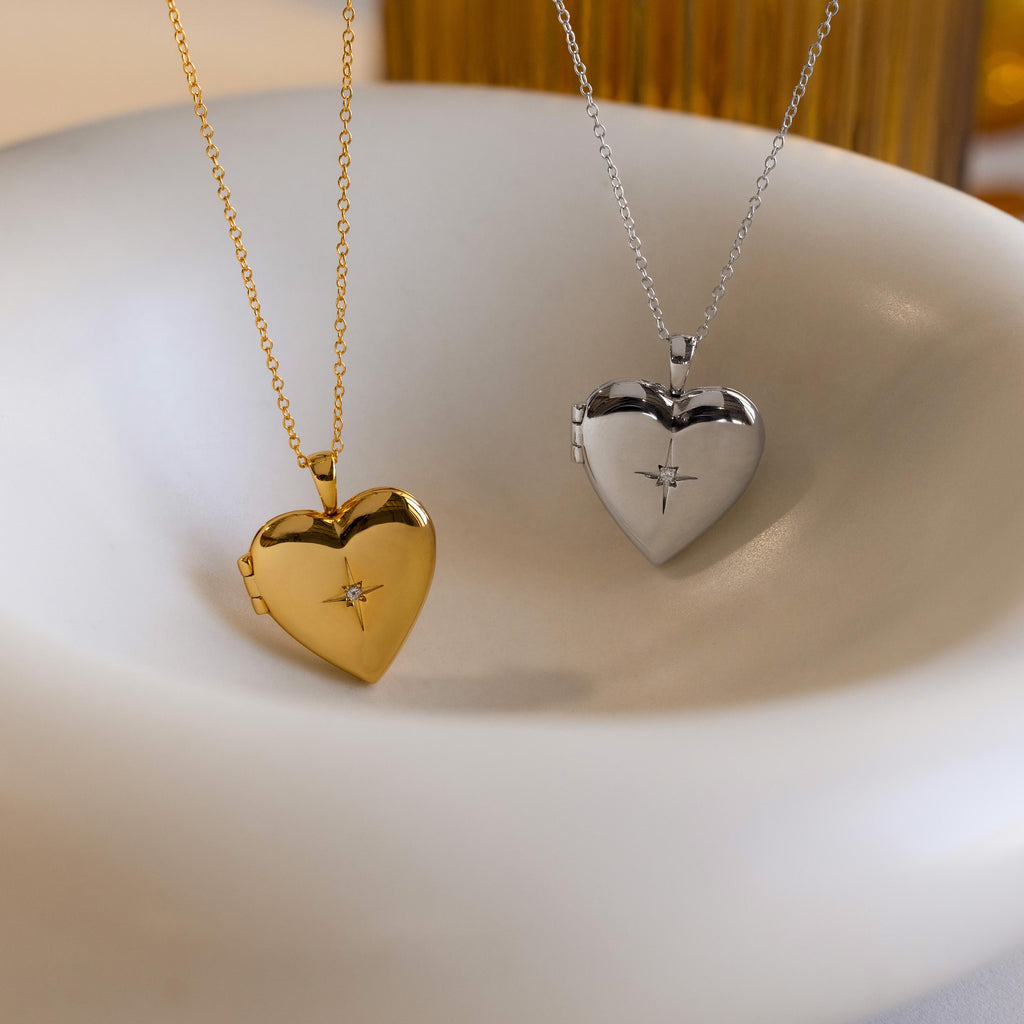A gold and silver heart-shaped locket with CZ diamond north star starburst details in the center.