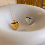 A gold and silver heart-shaped locket with CZ diamond north star starburst details in the center.