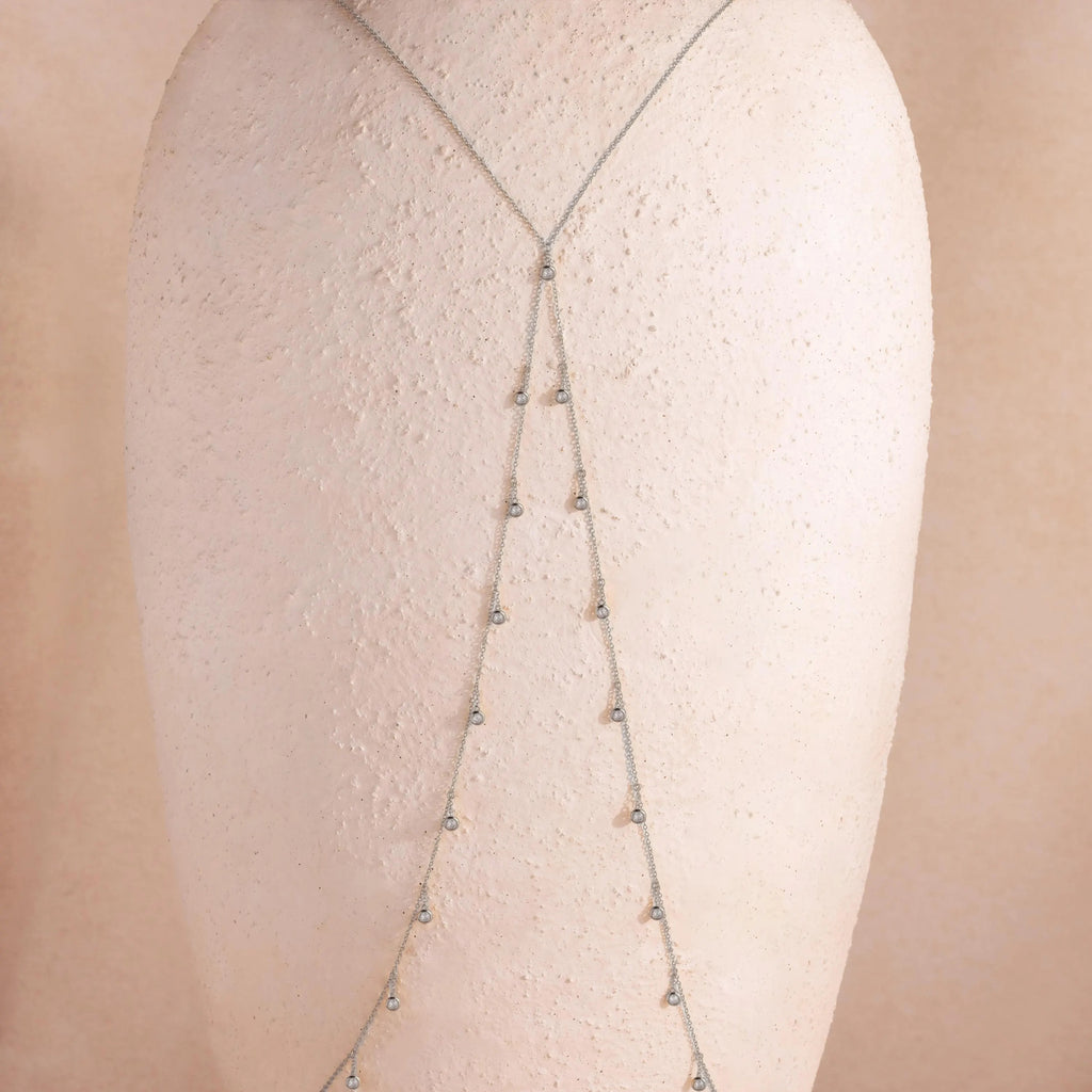 Sterling silver Diamond Station Body Chain draped on a textured bust form, showing the elegant fall and symmetrical crystal arrangement of the chain.