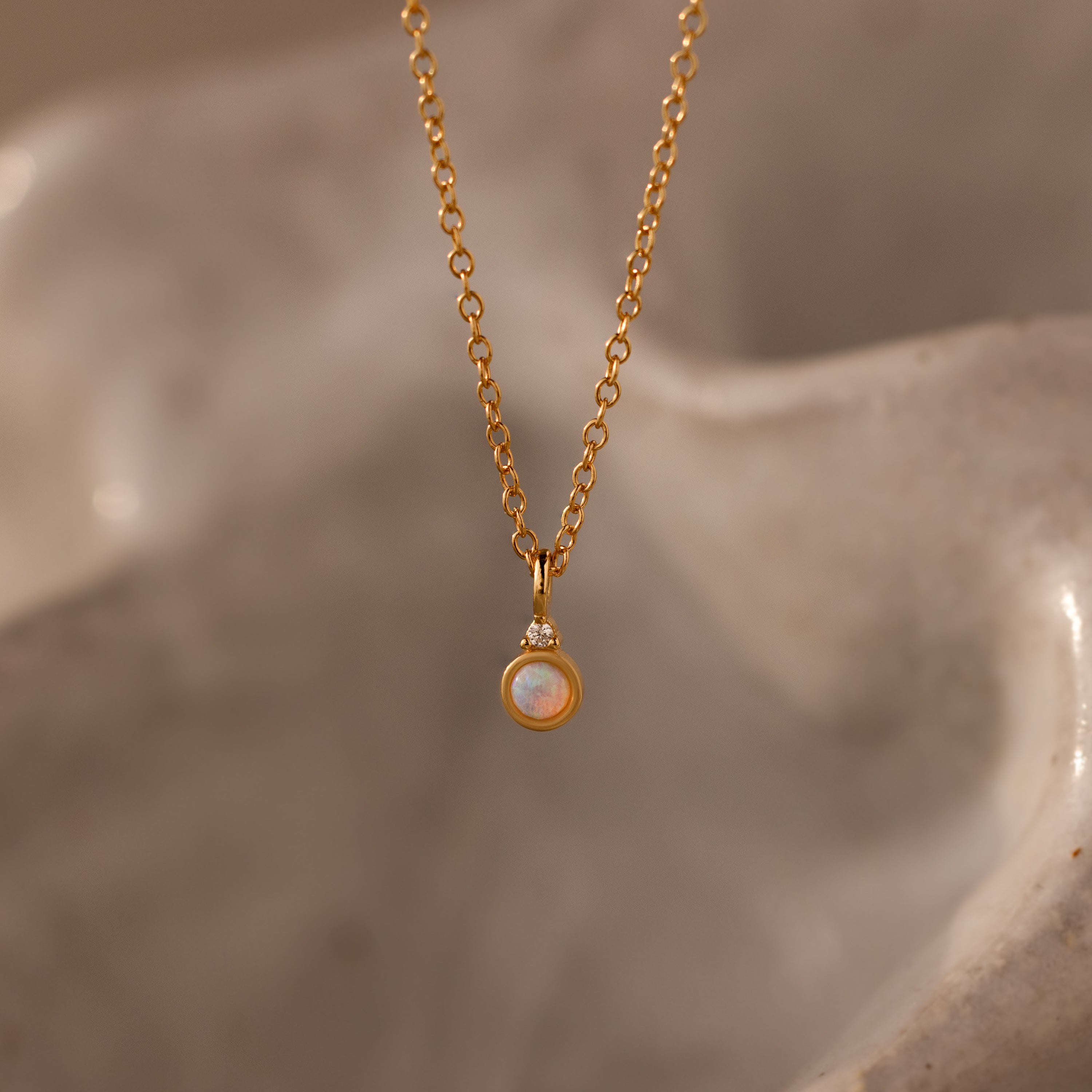 Close up image of our Opal Diamond Necklace in 18K Gold
