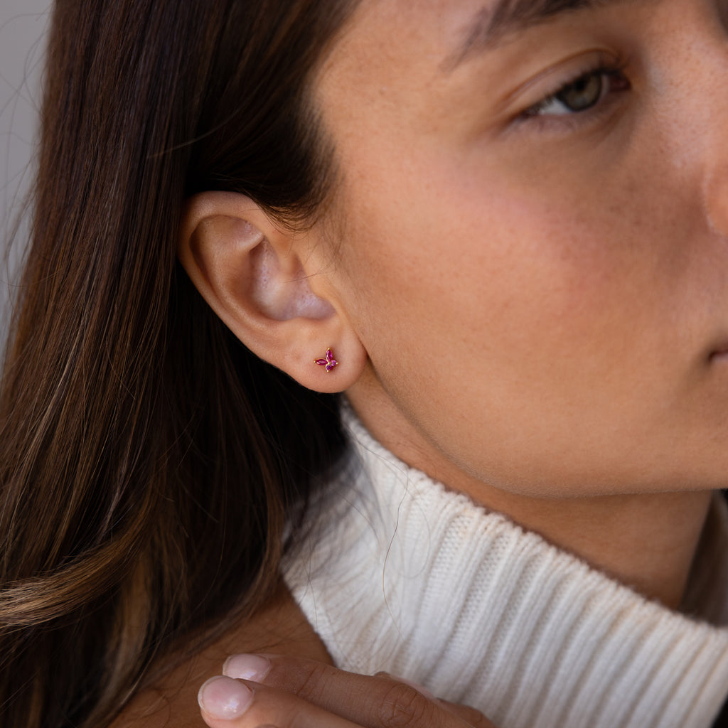 Woman wearing Butterfly Garnet Flatback Studs, styled with long brown hair and a white turtleneck sweater—ideal for fans of flatback earrings and personalized jewelry.