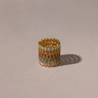 The Marquise Infinity Birthstone Ring, with vibrant gemstones arranged in multiple rows, rests on a neutral background and casts a gentle shadow.
