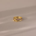 The Duo Alexandrite Tennis Linked Ring Set features small pink stones and a double loop design, elegantly displayed on a softly lit, neutral surface.
