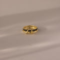 The Duo Birthstone Tennis Linked Ring Set in Onyx is displayed on a light, reflective surface.