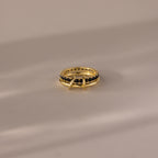 The Duo Birthstone Tennis Linked Ring Set in Onyx is displayed on a light, reflective surface.
