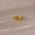 Duo Birthstone Tennis Linked Ring Set in Peridot (August), featuring a textured gold band with embedded stones, displayed on a soft, neutral surface.
