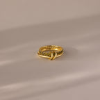 Duo Birthstone Tennis Linked Ring Set in Peridot (August), featuring a textured gold band with embedded stones, displayed on a soft, neutral surface.