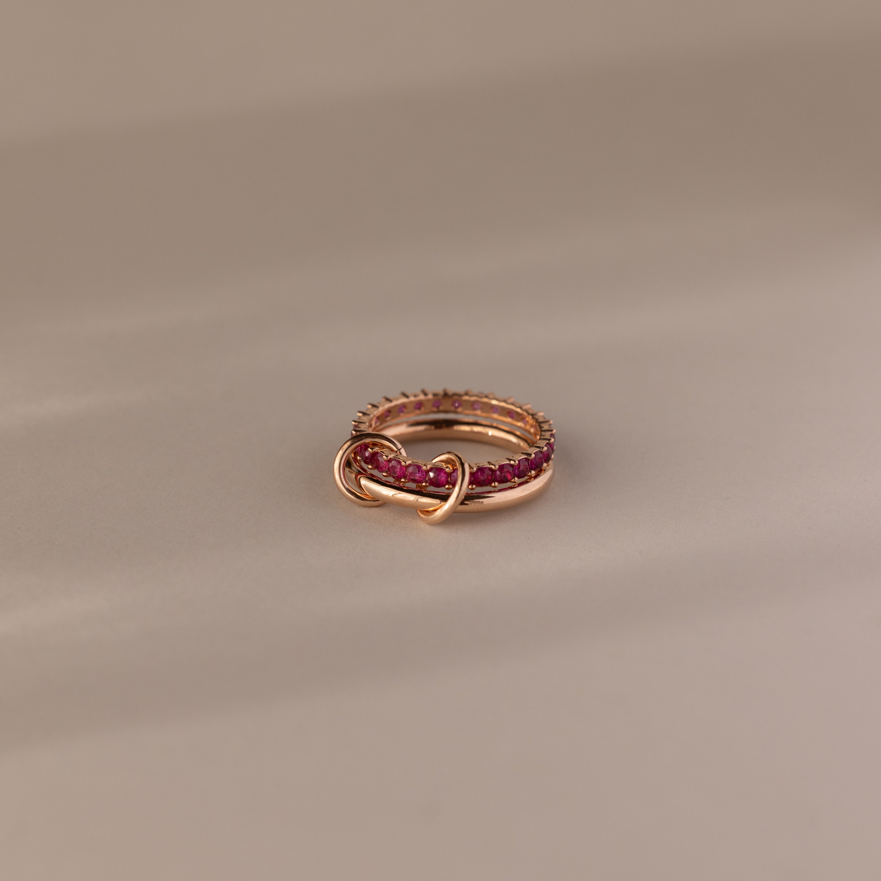 Duo Ruby Tennis Linked Ring Set—features minimalist gold bands linked and adorned with pink gemstones, creating an elegant heart-inspired design perfect as a birthstone ring for any occasion.