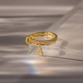 Linked Initial Birthstone Ring Set in Pink Tourmaline (October), displayed on a reflective light gray surface—an ideal personalized birthstone jewelry piece.