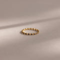 The Dainty Marquise Sapphire Ring showcases small dark sapphires in a marquise pattern, offering a touch of Art Deco elegance.