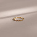 The Dainty Marquise Alexandrite Ring, featuring a delicate marquise-shaped design in gold, is displayed on a soft, neutral background.