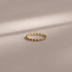 The Dainty Marquise Alexandrite Ring, featuring a delicate marquise-shaped design in gold, is displayed on a soft, neutral background.