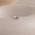 The Toi et Moi Interlocking Name Ring features two heart-shaped gemstones and engraved names, Elisa and Candice—a custom piece perfect for celebrating your unique bond.