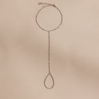 Sterling silver Curb Hand Chain Bracelet with the ring chain displayed on a neutral surface.
