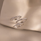 The Art Deco Diamond Ring Set features three elegant rings with unique band designs, displayed on soft beige fabric, evoking timeless vintage glamour.