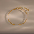 Dune Beaded Bracelet in 18K Gold features polished beads, an adjustable chain, and a heart charm, displayed on a neutral background.