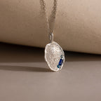 Organic Fingerprint Multi Birthstone Necklace with a fingerprint design and multiple birthstones, displayed on a neutral surface—an ideal personalized family keepsake for capturing cherished memories.