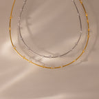The Sprinkle Diamond Necklace collection features two delicate chain necklaces, one gold and one silver, each adorned with sparkling stones—perfect for capturing everyday brilliance.