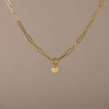 Paperclip Heart Charm Necklace in 18K Gold with elongated links and a delicate heart pendant, displayed on a neutral background—the perfect accessory for subtle elegance with any outfit.