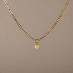 Paperclip Heart Charm Necklace in 18K Gold with elongated links and a delicate heart pendant, displayed on a neutral background—the perfect accessory for subtle elegance with any outfit.