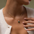 Close up of model wearing our Emerald Bloom Necklace with Pink Tourmaline and Emerald gemstones