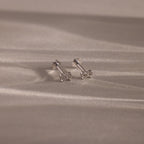 Flatlay image of our Tiny Bow Flatback Studs in Sterling Silver