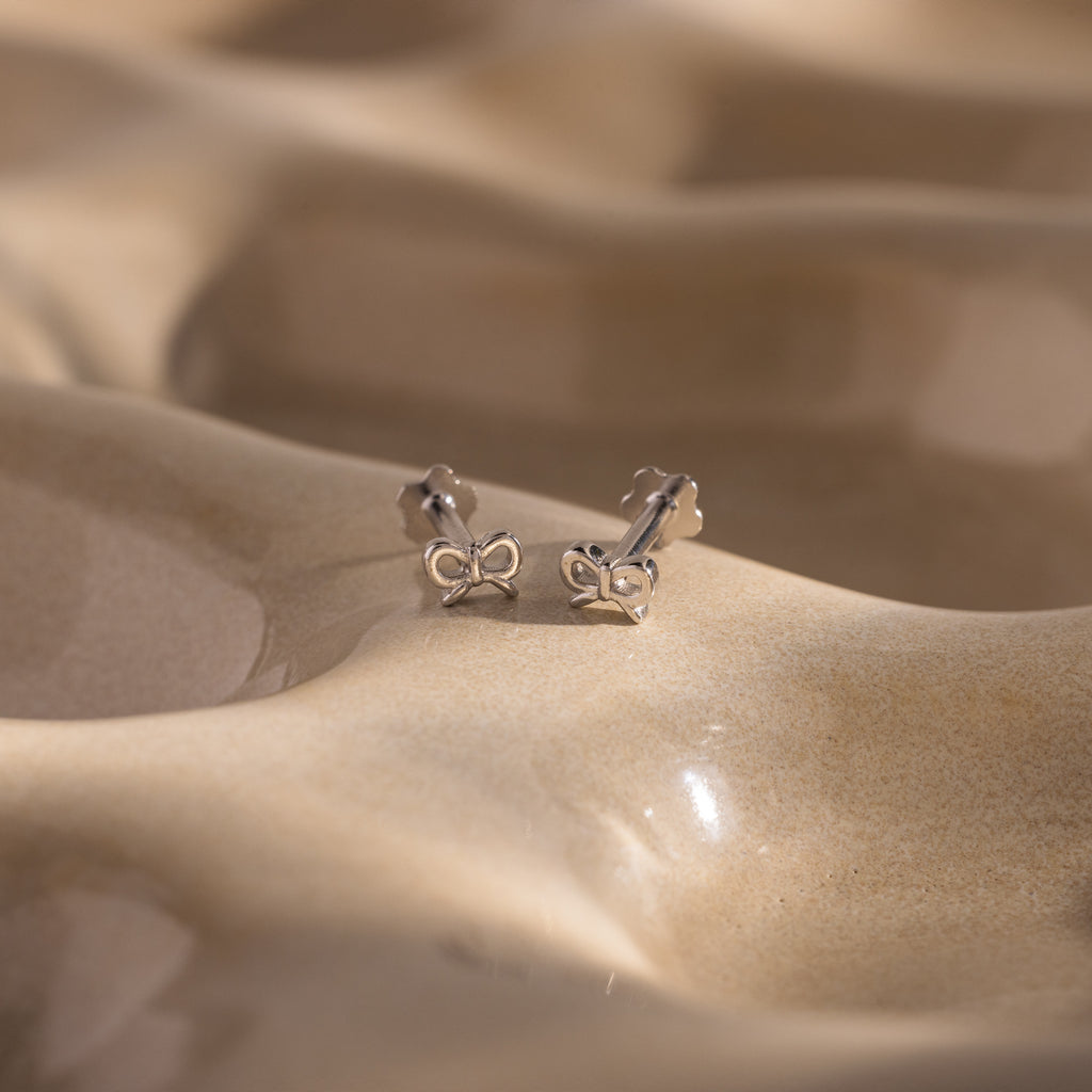 Close up of our Tiny Bow Flatback Studs in Silver