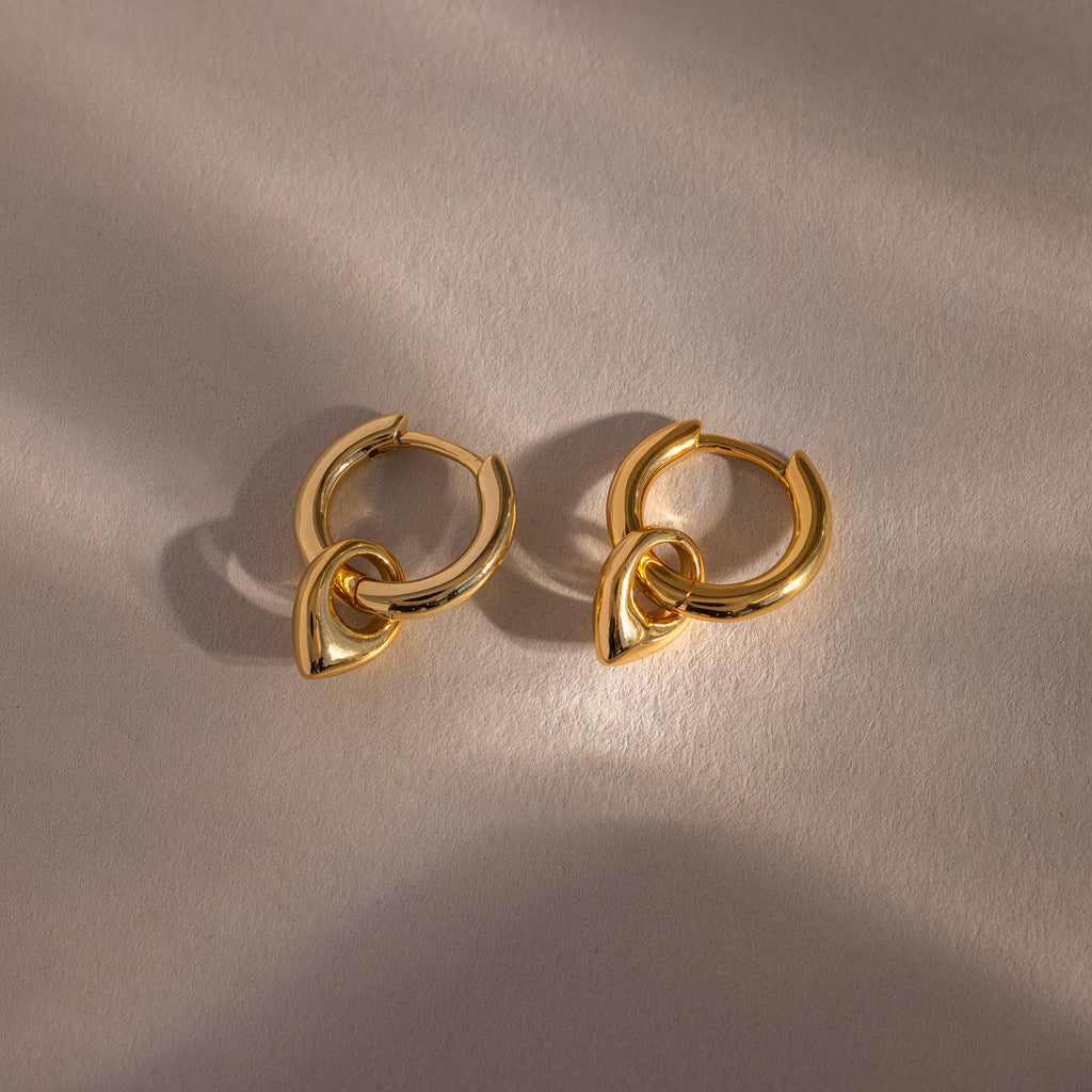 Close up flatlay of our Tiny Teardrop Huggies in Gold
