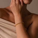 A woman showcases the Diamond Heart Rope Bracelet, her hand near her face against a neutral backdrop.