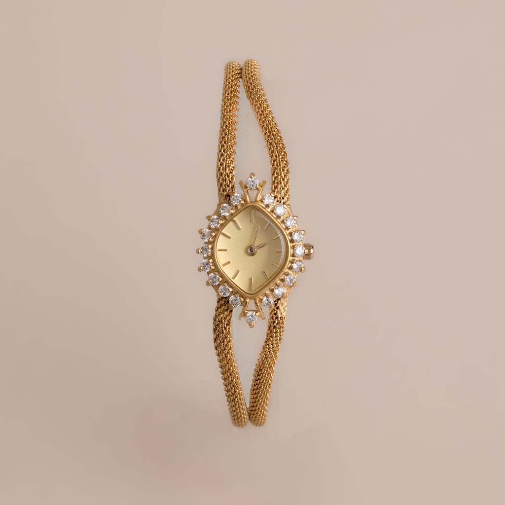 Our Duo Chain Diamond Timepiece on a beige background