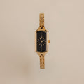 Close up of our Midnight Link Timepiece watch against a beige background