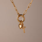 Cross & Heart Charm Bracelet in 18K Gold shown on a neutral background, featuring cross and heart charms that evoke an elegant, timeless style.