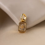 Up close of a clear diamond north star charm with a delicate pavé diamond in the center.