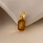 Up close of a yellow topaz north star charm with a pavé CZ diamond in the center.