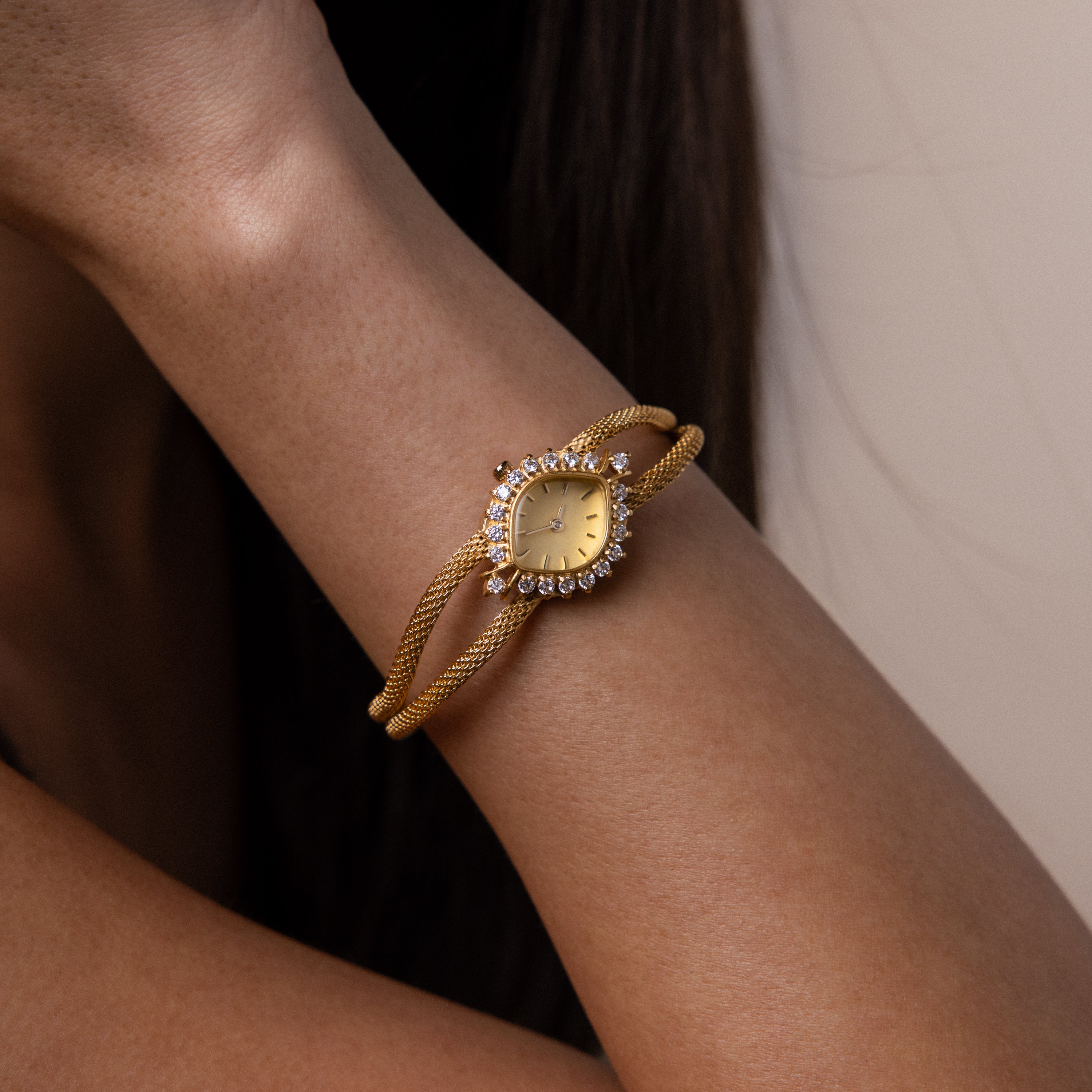 Close up of a model's wrist wearing our Duo Chain Diamond Timepiece watch