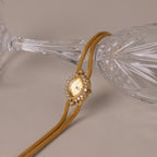 Close up of our Duo Chain Diamond Timepiece watch against a clear glass cup