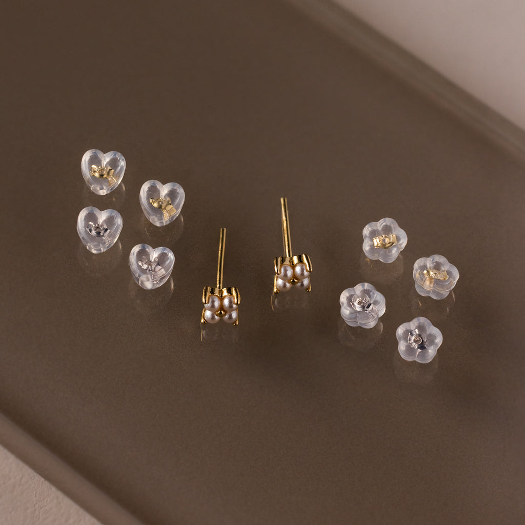 Five pairs of sterling silver heart and flower stud earrings with secure, comfortable silicone backs—essential earring styles for everyday wear.