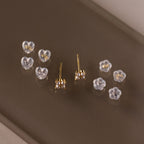 Five pairs of sterling silver heart and flower stud earrings with secure, comfortable silicone backs—essential earring styles for everyday wear.