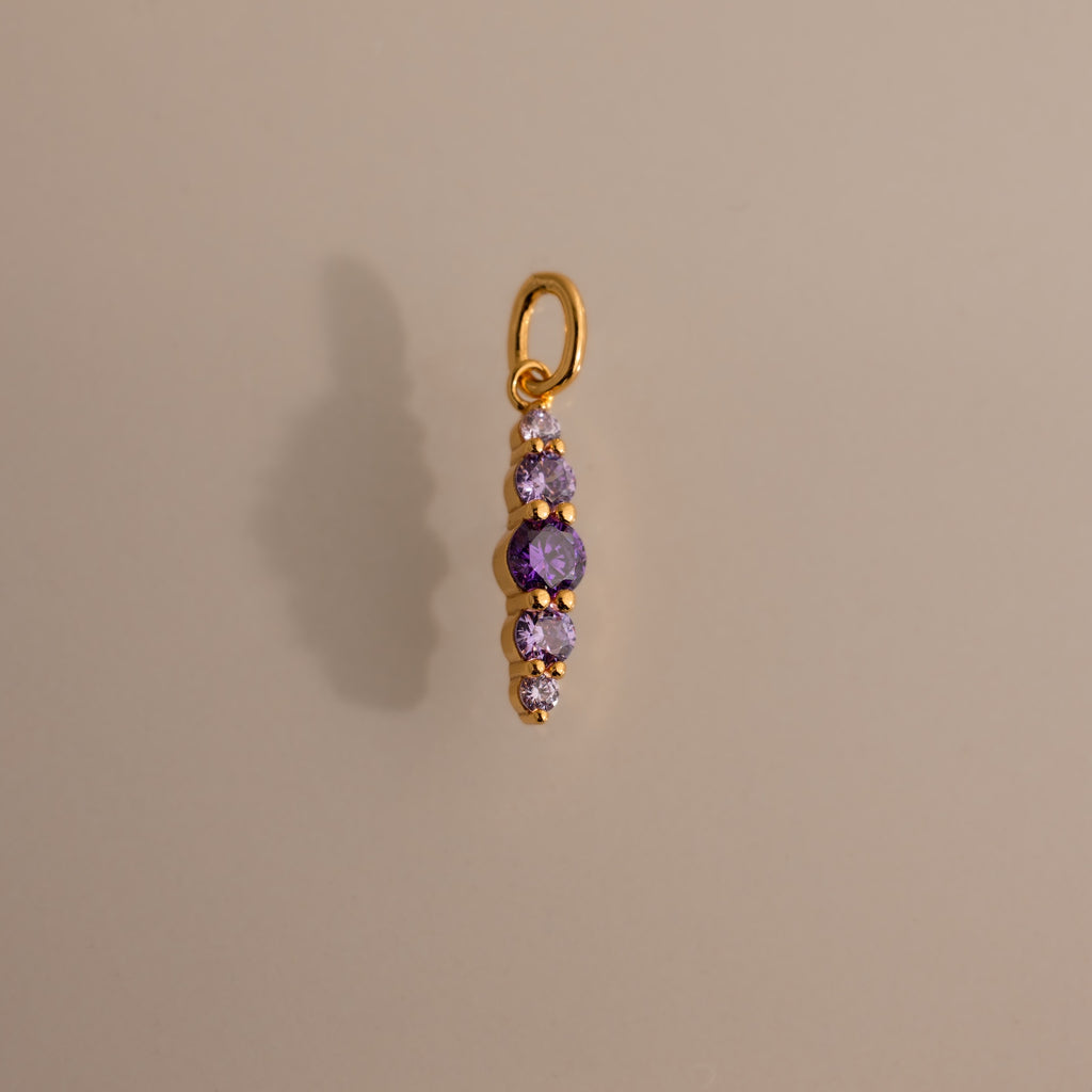 Ombre Lace Alexandrite Charm pendant featuring five small purple gemstones arranged vertically on a neutral background.