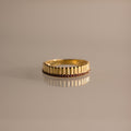 Ribbed Garnet Stack Ring with a ridged design and a row of small red garnets, ideal for stacking with your favorite rings. Shown on a neutral background.