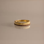 Ribbed Garnet Stack Ring with a ridged design and a row of small red garnets, ideal for stacking with your favorite rings. Shown on a neutral background.