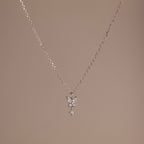 Butterfly Drop Necklace in Sterling Silver features a delicate butterfly pendant, ideal for nature-inspired jewelry lovers, and is shown on a plain beige background.