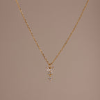 Butterfly Drop Necklace in 18K Gold features a delicate butterfly pendant, shown on a plain beige background—a perfect piece for lovers of nature-inspired jewelry.