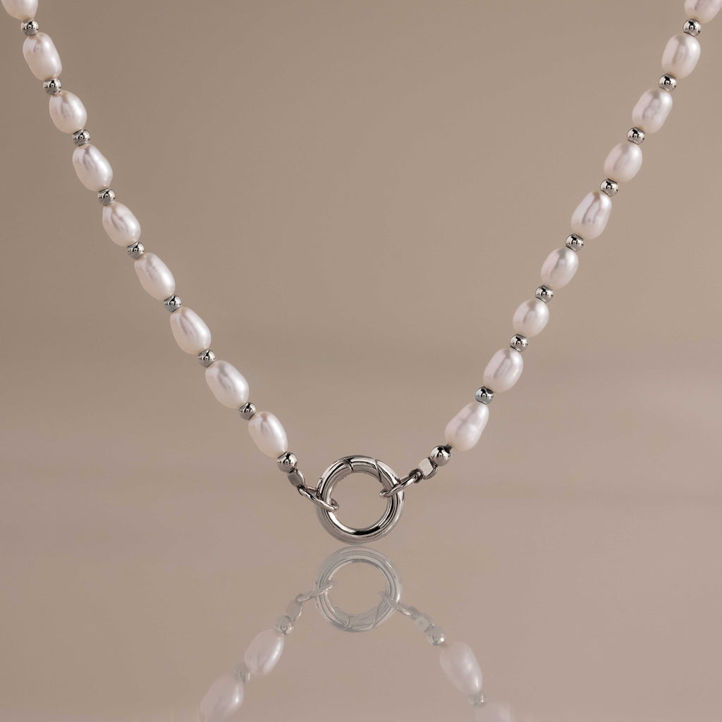 Sterling silver pearl station necklace with freshwater pearls and a front-facing rolo charm clasp.