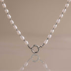 Sterling silver pearl station necklace with freshwater pearls and a front-facing rolo charm clasp.