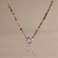 Sunstone beaded necklace with warm, glowing beads and a silver O-ring clasp, reflecting a boho style.