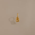 The Bubble Letter Charm in 18K Gold, shaped like a "B," is displayed on a beige background—ideal as personalized jewelry or a chic addition to your charm bracelet collection.