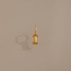 The Bubble Letter Charm in 18K Gold, shaped like the letter I, rests on a plain beige background—an elegant piece of personalized jewelry.