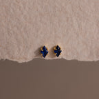 A pair of Rhombus Sapphire Flatback Studs, ideal for adding understated charm and modern glamour to any look.