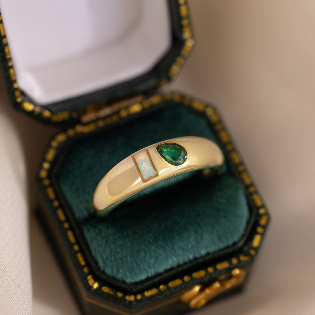 Toi et Moi Dome Ring in 18K Gold featuring a green teardrop gem and rectangular opal, elegantly presented in a vintage green velvet ring box.